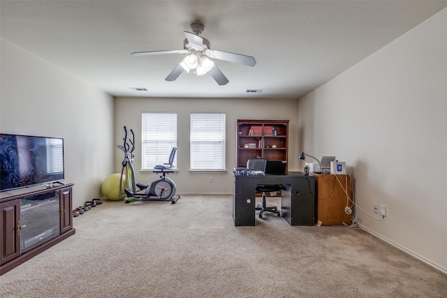 carpeted office featuring ceiling fan, visible vents, and baseboards