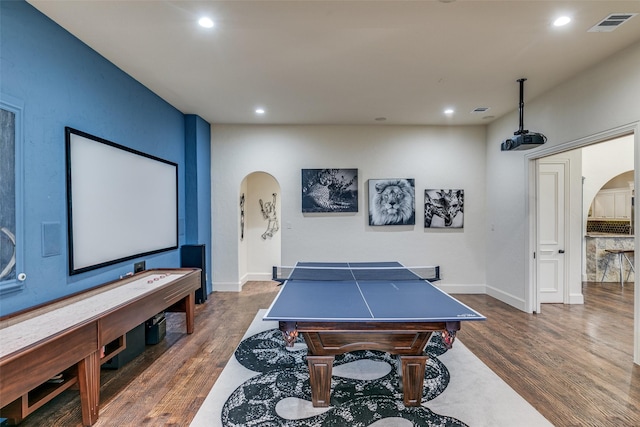 playroom featuring arched walkways, recessed lighting, visible vents, dark wood-type flooring, and baseboards