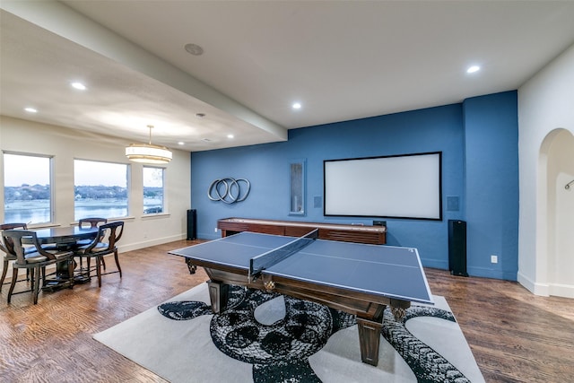 game room featuring arched walkways, recessed lighting, wood finished floors, and baseboards