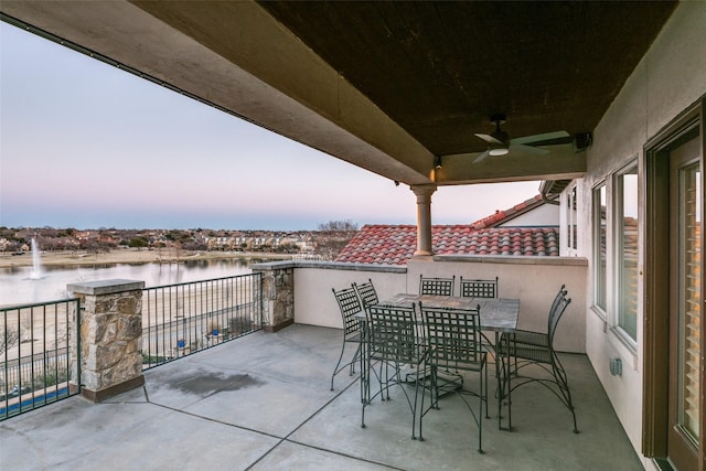 view of patio featuring ceiling fan and a water view