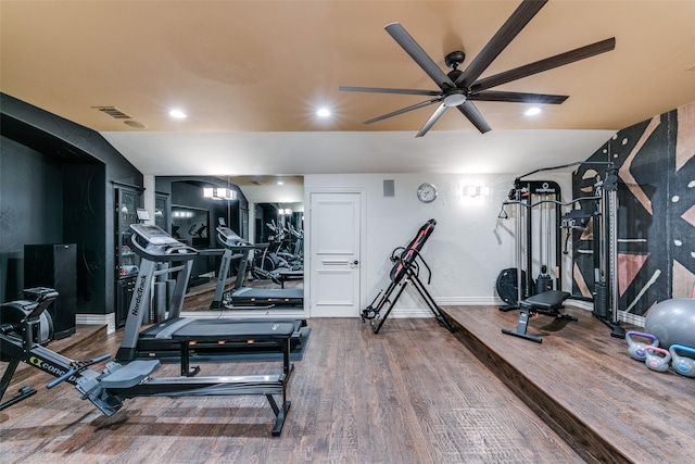 interior space featuring recessed lighting, wood finished floors, visible vents, baseboards, and vaulted ceiling