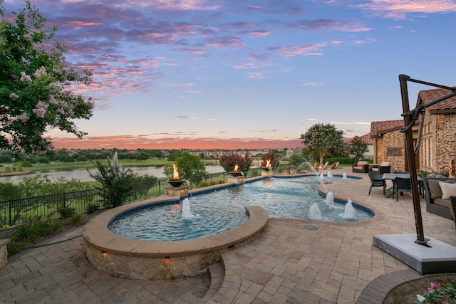 view of swimming pool featuring a water view, fence, and a patio