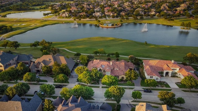 drone / aerial view featuring a water view, a residential view, and golf course view