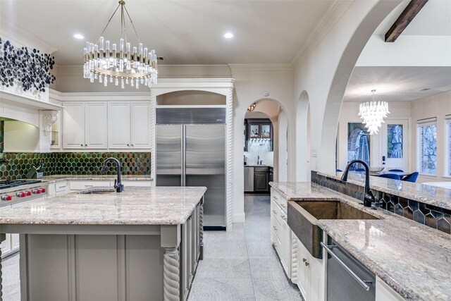 kitchen featuring stainless steel appliances, white cabinets, visible vents, and tasteful backsplash