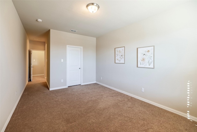 unfurnished bedroom featuring baseboards, visible vents, and carpet flooring