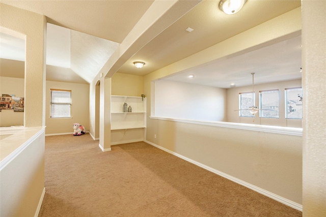 hallway featuring carpet floors and baseboards