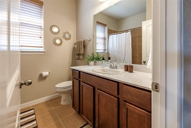 full bathroom with toilet, vanity, a wealth of natural light, and tile patterned floors