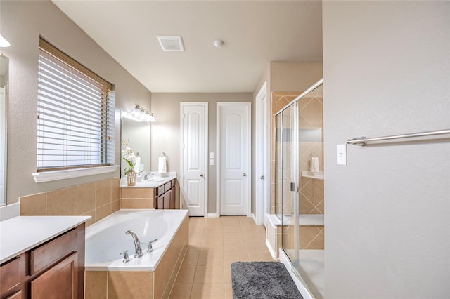 bathroom featuring a stall shower, visible vents, a garden tub, tile patterned flooring, and vanity