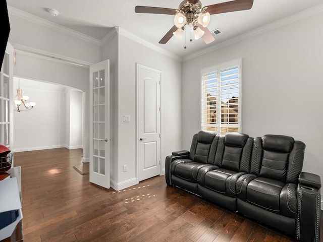 living area with arched walkways, visible vents, hardwood / wood-style flooring, and crown molding