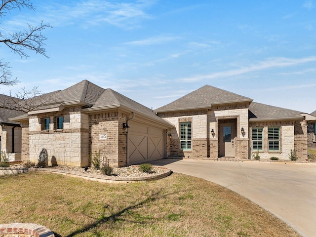 view of front of house featuring a shingled roof, concrete driveway, brick siding, and an attached garage