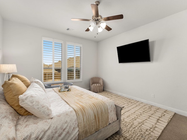 bedroom with carpet, visible vents, baseboards, and ceiling fan