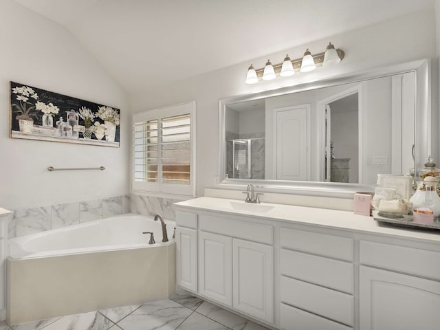 bathroom with marble finish floor, lofted ceiling, a stall shower, vanity, and a bath