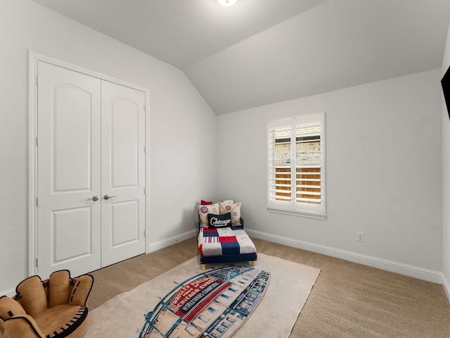 living area featuring lofted ceiling, carpet, and baseboards