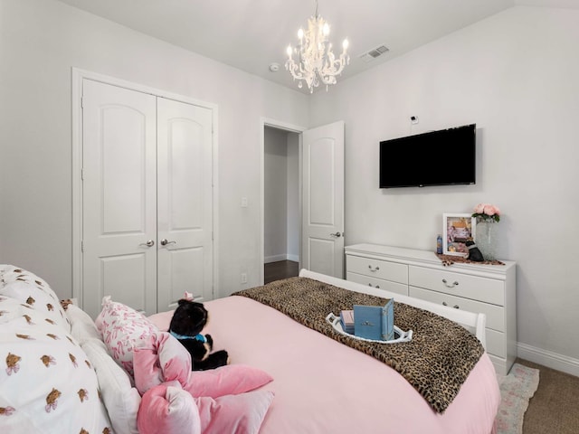 bedroom with a closet, visible vents, carpet flooring, a chandelier, and baseboards