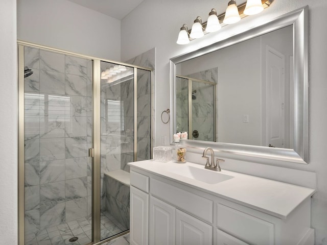 full bathroom with a marble finish shower and vanity