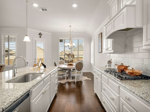 kitchen featuring stainless steel appliances, a sink, visible vents, ornamental molding, and custom exhaust hood