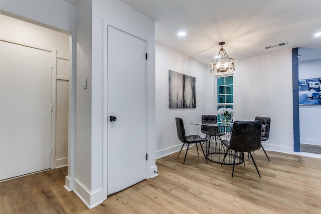 dining space with visible vents, baseboards, and wood finished floors