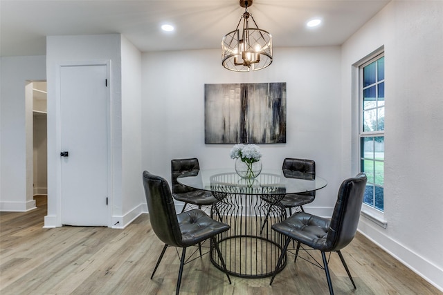 dining space with an inviting chandelier, baseboards, wood finished floors, and recessed lighting