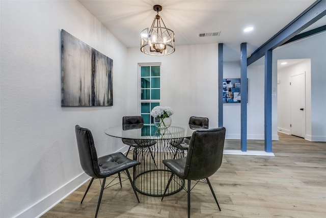 dining area with recessed lighting, visible vents, light wood-style flooring, an inviting chandelier, and baseboards