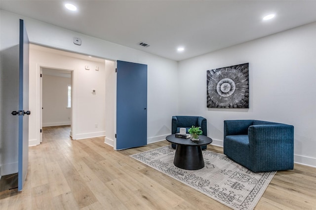 sitting room featuring baseboards, light wood-type flooring, visible vents, and recessed lighting