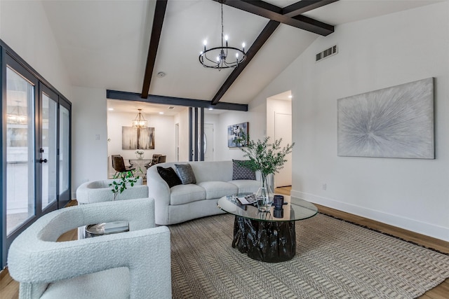 living room featuring baseboards, visible vents, wood finished floors, vaulted ceiling with beams, and an inviting chandelier