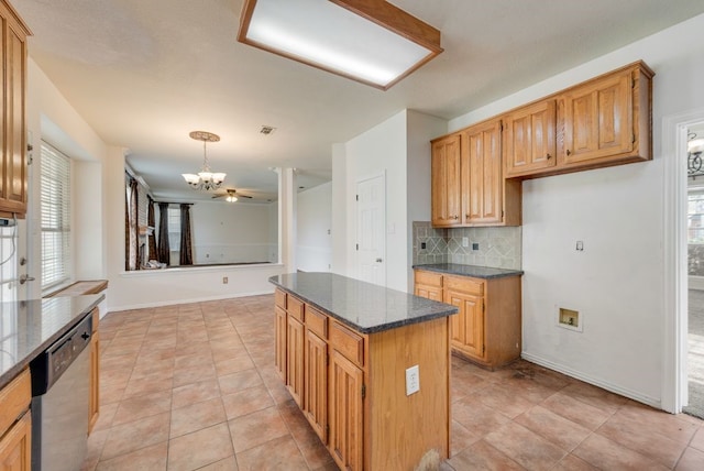 kitchen featuring a center island, visible vents, backsplash, stainless steel dishwasher, and dark stone countertops