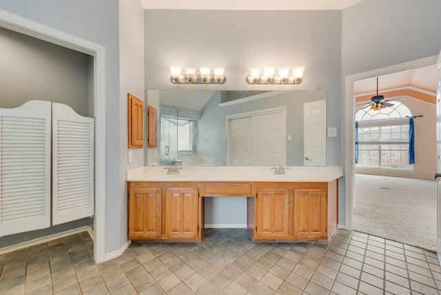 full bath featuring a wealth of natural light, double vanity, vaulted ceiling, and ceiling fan