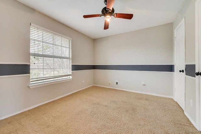 unfurnished room with ceiling fan, baseboards, and carpet flooring