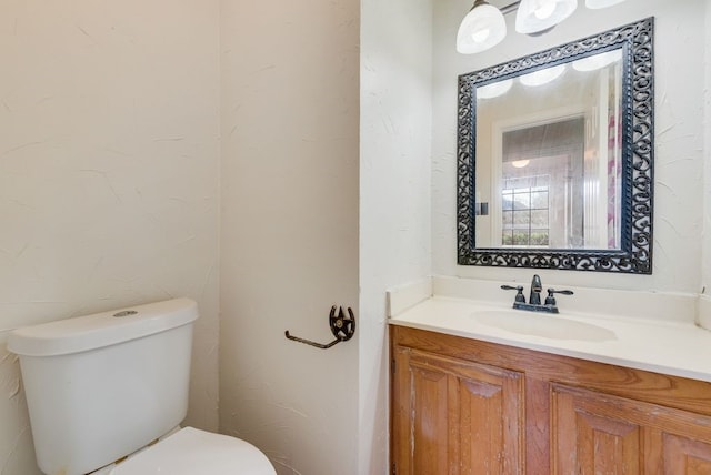 bathroom with toilet and vanity