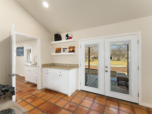 entryway featuring french doors, lofted ceiling, recessed lighting, a sink, and baseboards