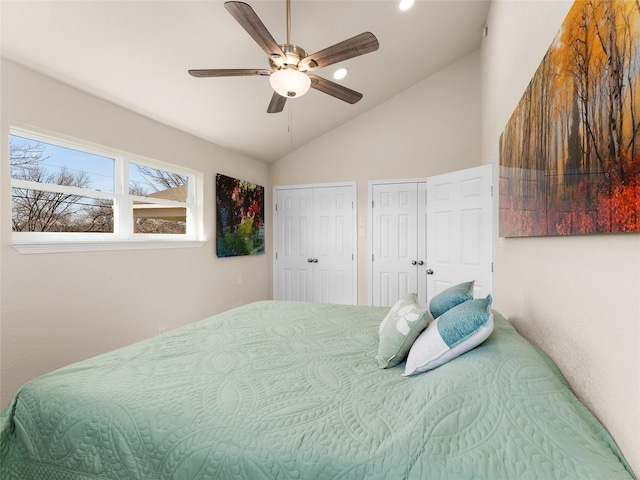 bedroom featuring lofted ceiling, ceiling fan, and multiple closets