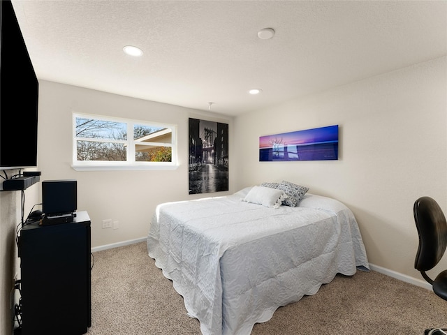 carpeted bedroom featuring baseboards, a textured ceiling, and recessed lighting