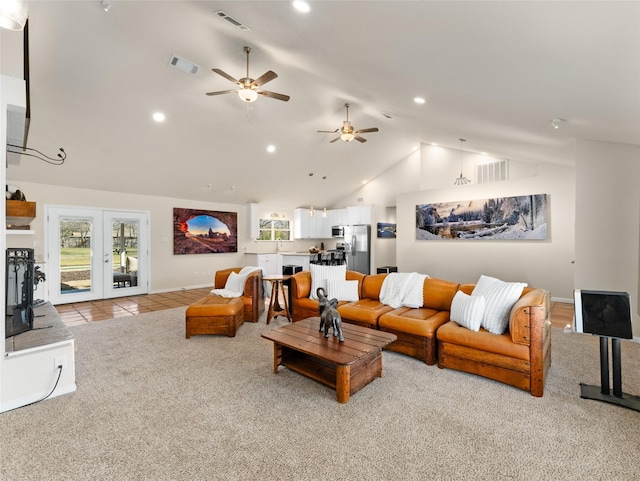 living room with carpet, tile patterned flooring, and visible vents