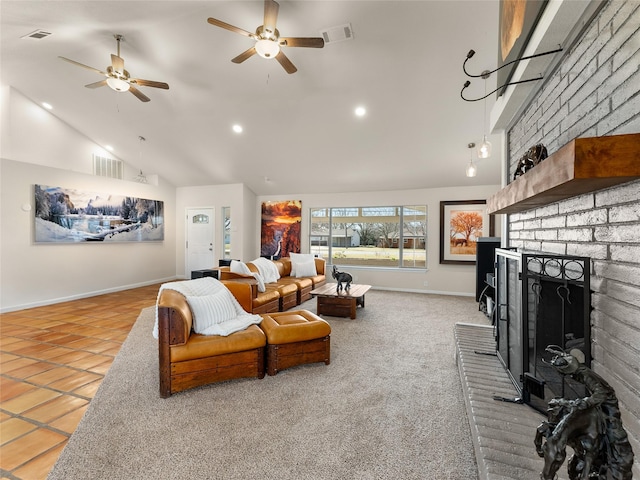 tiled living room with high vaulted ceiling, a brick fireplace, and visible vents