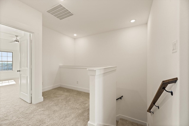 hall with recessed lighting, carpet, visible vents, and an upstairs landing