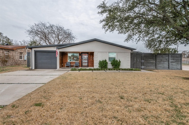 view of front of home featuring a front yard, concrete driveway, and an attached garage