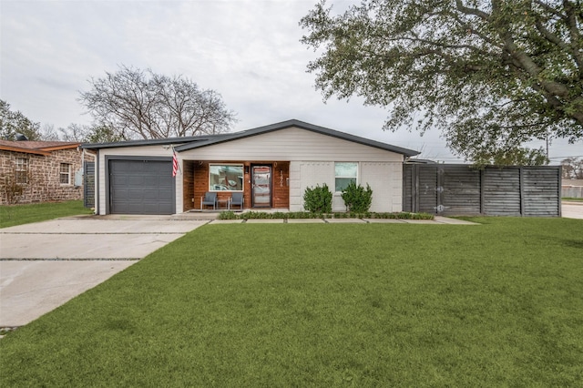 view of front facade with a front lawn, an attached garage, brick siding, and driveway