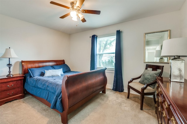 bedroom with ceiling fan, baseboards, and light carpet