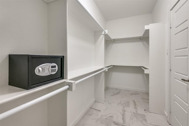 spacious closet featuring marble finish floor