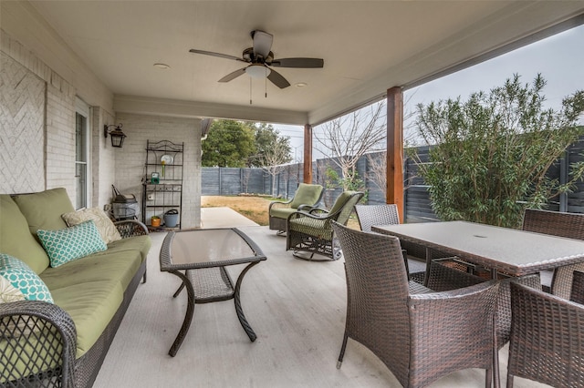 view of patio / terrace featuring outdoor lounge area, outdoor dining area, a fenced backyard, and ceiling fan