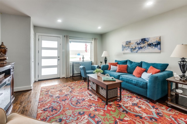 living room featuring recessed lighting, baseboards, and wood finished floors