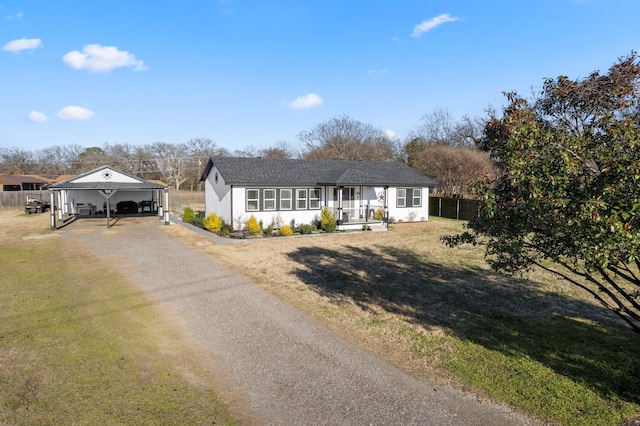 single story home with driveway, fence, and a front lawn