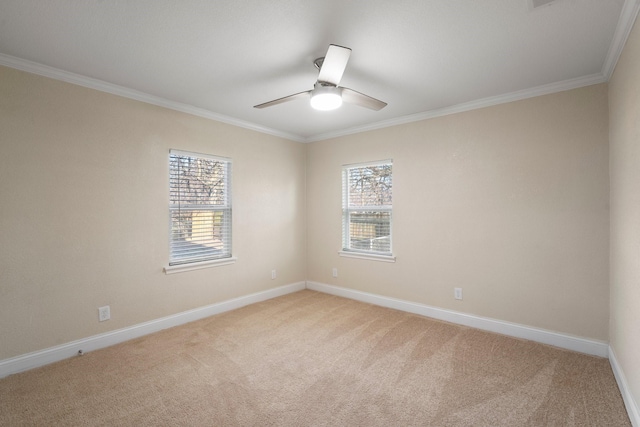 spare room featuring light carpet, baseboards, ornamental molding, and ceiling fan