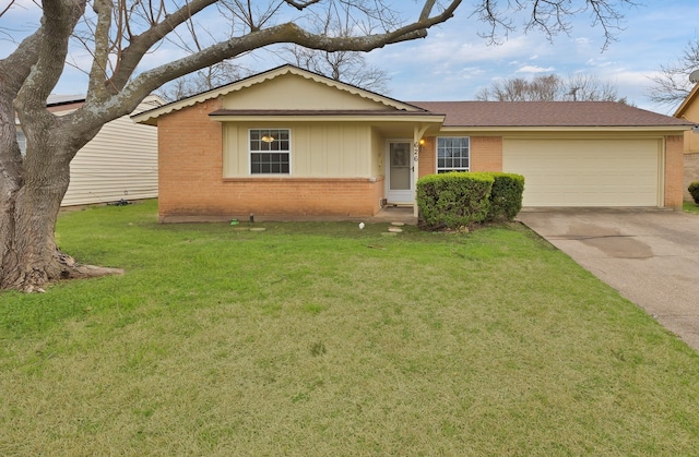 single story home featuring an attached garage, concrete driveway, brick siding, and a front yard