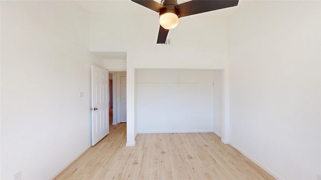 empty room featuring ceiling fan, baseboards, and light wood-style floors