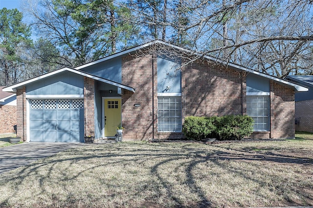 mid-century home featuring a garage, driveway, a front lawn, and brick siding