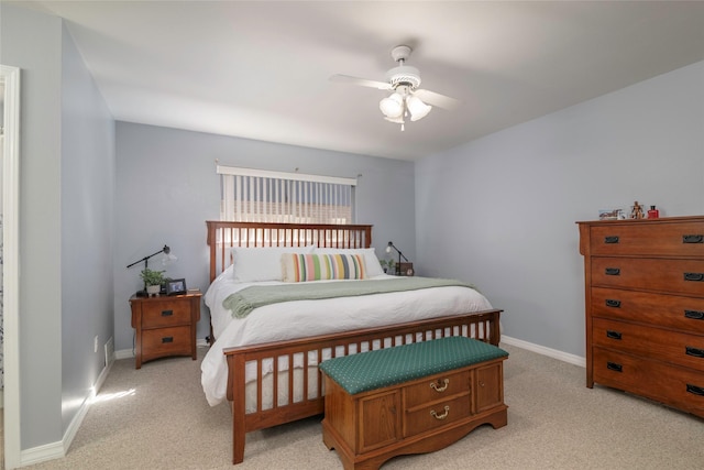 bedroom featuring baseboards, a ceiling fan, and light colored carpet