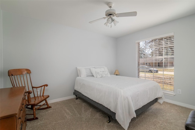 carpeted bedroom with baseboards and a ceiling fan