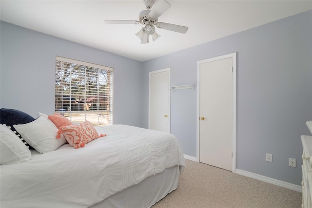 bedroom featuring baseboards, a ceiling fan, and light colored carpet