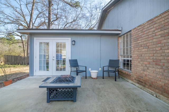 view of patio / terrace featuring french doors, an outdoor fire pit, and fence